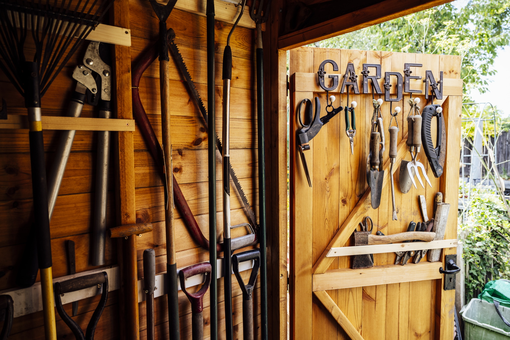 Interior of wooden gardening shed with neatly arranged tools